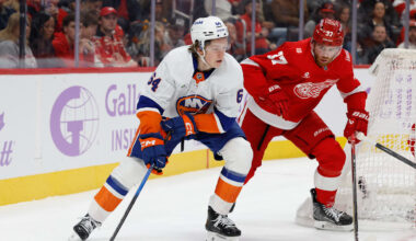 Nov 20, 2025; Detroit, Michigan, USA;  New York Islanders center Calum Ritchie (64) skates with the puck defended by Detroit Red Wings left wing J.T. Compher (37) in the first period at Little Caesars Arena. Mandatory Credit: Rick Osentoski-Imagn Images