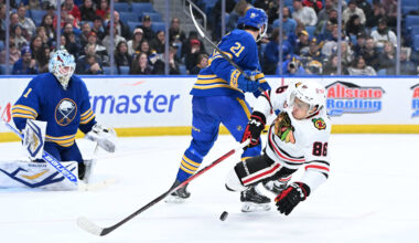 Nov 21, 2025; Buffalo, New York, USA; Chicago Blackhawks center Teuvo Teravainen (86) is knocked off his skates by Buffalo Sabres defenseman Conor Timmins (21) in front of goaltender Ukko-Pekka Luukkonen (1) in the third period at KeyBank Center. Mandatory Credit: Mark Konezny-Imagn Images