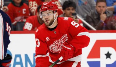 Nov 22, 2025; Detroit, Michigan, USA;  Detroit Red Wings right wing Alex Debrincat (93) skates with the puck defended by Columbus Blue Jackets center Adam Fantilli (19) in overtime at Little Caesars Arena. Mandatory Credit: Rick Osentoski-Imagn Images