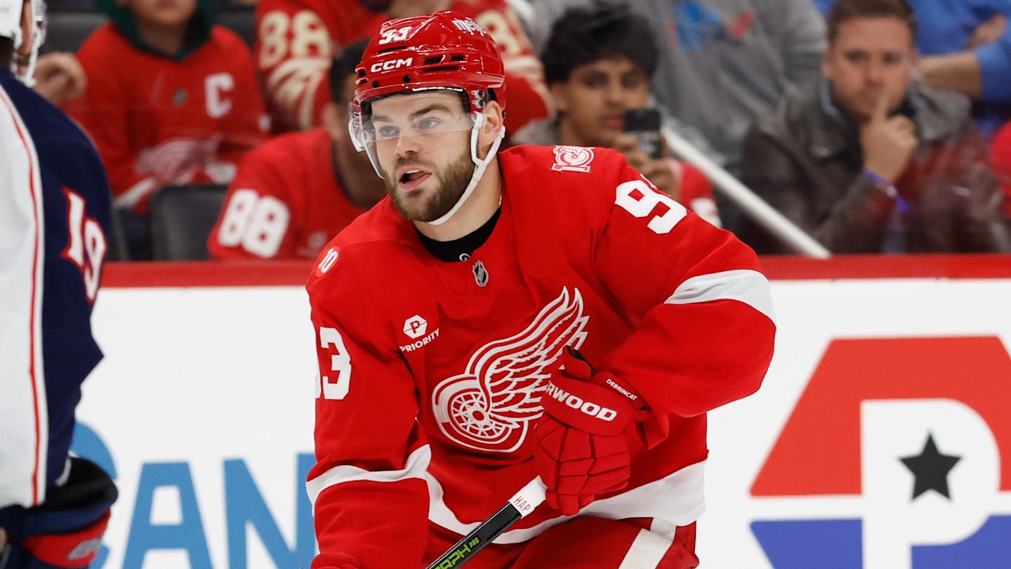 Nov 22, 2025; Detroit, Michigan, USA;  Detroit Red Wings right wing Alex Debrincat (93) skates with the puck defended by Columbus Blue Jackets center Adam Fantilli (19) in overtime at Little Caesars Arena. Mandatory Credit: Rick Osentoski-Imagn Images