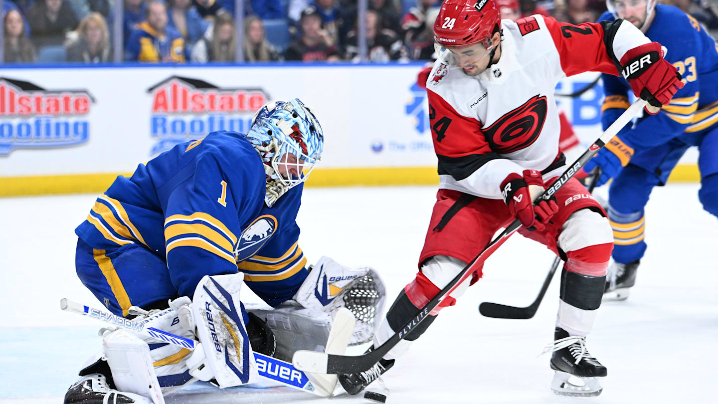 Nov 23, 2025; Buffalo, New York, USA; Carolina Hurricanes center Seth Jarvis (24) tries to get the puck past Buffalo Sabres goaltender Ukko-Pekka Luukkonen (1) in the first period at KeyBank Center. Mandatory Credit: Mark Konezny-Imagn Images
