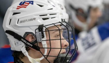 Feb 7, 2024; Plymouth, MI, USA; USA s James Hagens (10) watches the action from the bench against Finland during the third period of the 2024 U18 s Five Nations Tournament at USA Hockey Arena. Mandatory Credit: David Reginek-Imagn Images
