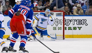 Nov 24, 2025; New York, New York, USA;  St. Louis Blues goaltender Joel Hofer (30) makes a glove save against the New York Rangers during the first period at Madison Square Garden. Mandatory Credit: Dennis Schneidler-Imagn Images
