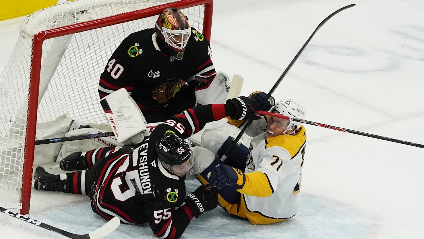 Nov 28, 2025; Chicago, Illinois, USA; Chicago Blackhawks defenseman Artyom Levshunov (55) is penalized for interfering with Nashville Predators right wing Matthew Wood (71) during the second period at United Center. Mandatory Credit: David Banks-Imagn Images