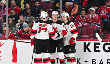 Simon Nemec and Luke Hughes celebrate a goal with New Jersey Devils teammate Dawson Mercer