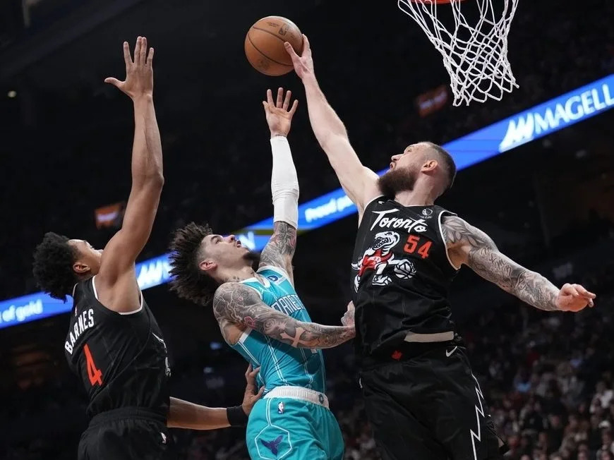  Toronto Raptors forward/center Sandro Mamukelashvili (54) rejects the shot from Charlotte Hornets guard Lamelo Ball (1) as Raptors forward/guard Scottie Barnes (4) looks on during first half NBA basketball action in Toronto on Monday, November 17, 2025.