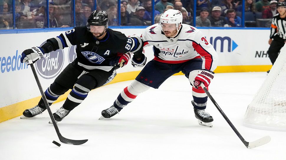 Tampa Bay Lightning right wing Nikita Kucherov (86) works around Washington Capitals defenseman Matt Roy (3) during the second period of an NHL hockey game Saturday, Nov. 8, 2025, in Tampa, Fla. (AP Photo/Chris O'Meara)