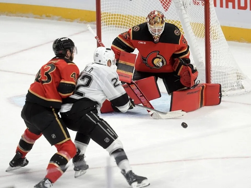  Kings forward Kevin Fiala directs the puck toward Senators goaltender Linus Ullmark under pressure from Ottawa defenceman Tyler Kleven.