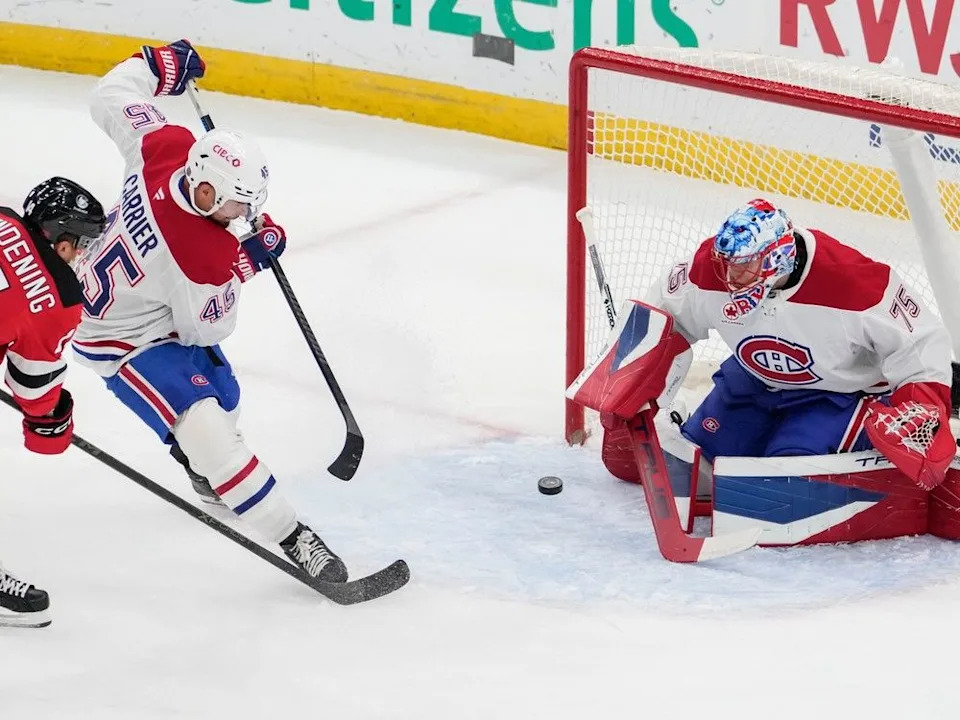  Montreal Canadiens goaltender Jakub Dobes (75) protect the net from New Jersey Devils center Luke Glendening (14) during the first period of an NHL hockey game, Thursday, Nov. 6, 2025, in Newark, N.J.