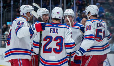 New York Rangers defenseman Vladislav Gavrikov, left, forward Noah Laba, second from left, defenseman Adam Fox (23), forward Alexis Lafreniere (13) and forward Will Cuylle celebrate a goal during the first period of an NHL hockey game against the Seattle Kraken, Saturday, Nov. 1, 2025, in Seattle. (AP Photo/Stephen Brashear)