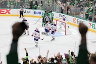 Dallas Stars players and crowd celebrate a goal scored by right wing Mikko Rantanen during...