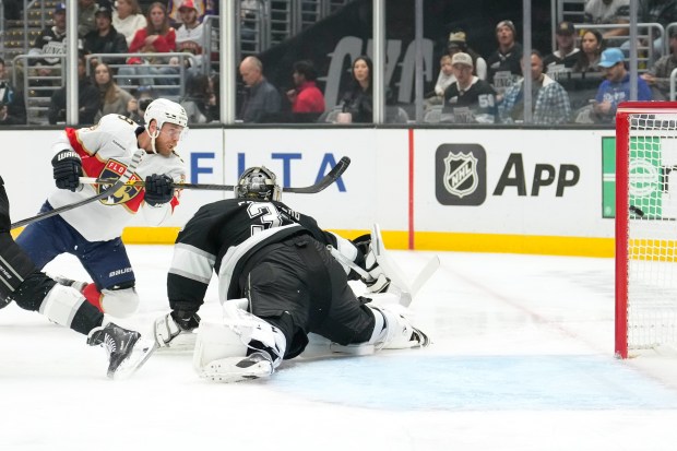 Florida Panthers center Sam Bennett, left, scores on Kings goaltender...