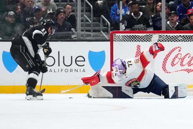 Florida Panthers goaltender Sergei Bobrovsky, right, stops a shot by...