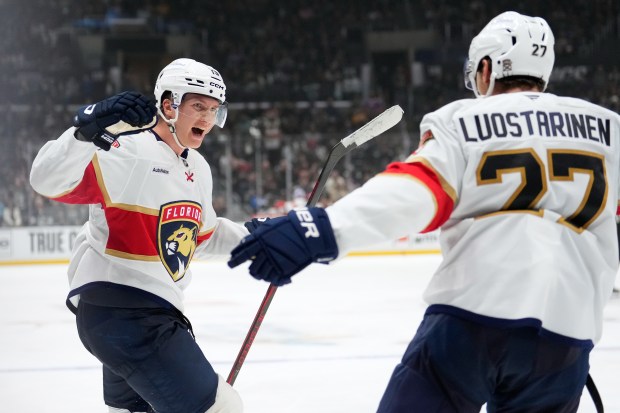 Florida Panthers center Anton Lundell, left, celebrates his goal with...