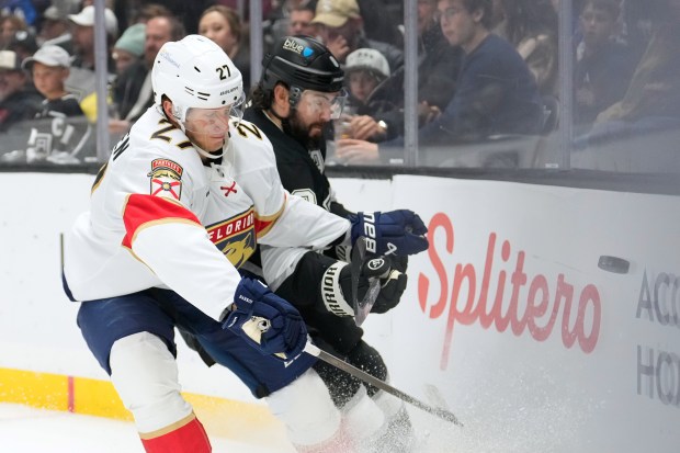 Florida Panthers center Eetu Luostarinen, left, and Kings defenseman Drew...