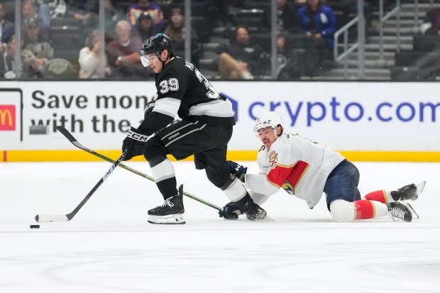 Florida Panthers defenseman Donovan Sebrango, right, falls to the ice...