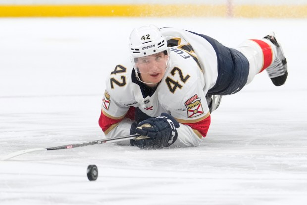 Florida Panthers defenseman Gustav Forsling falls to the ice as...