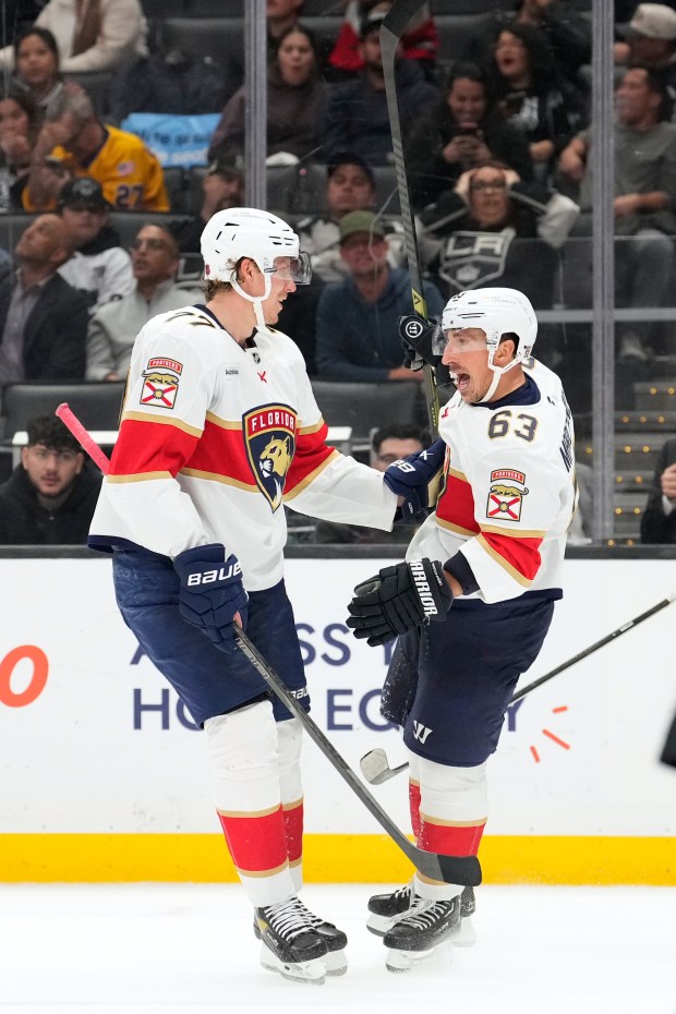 Florida Panthers left wing Brad Marchand, right, celebrates his goal...