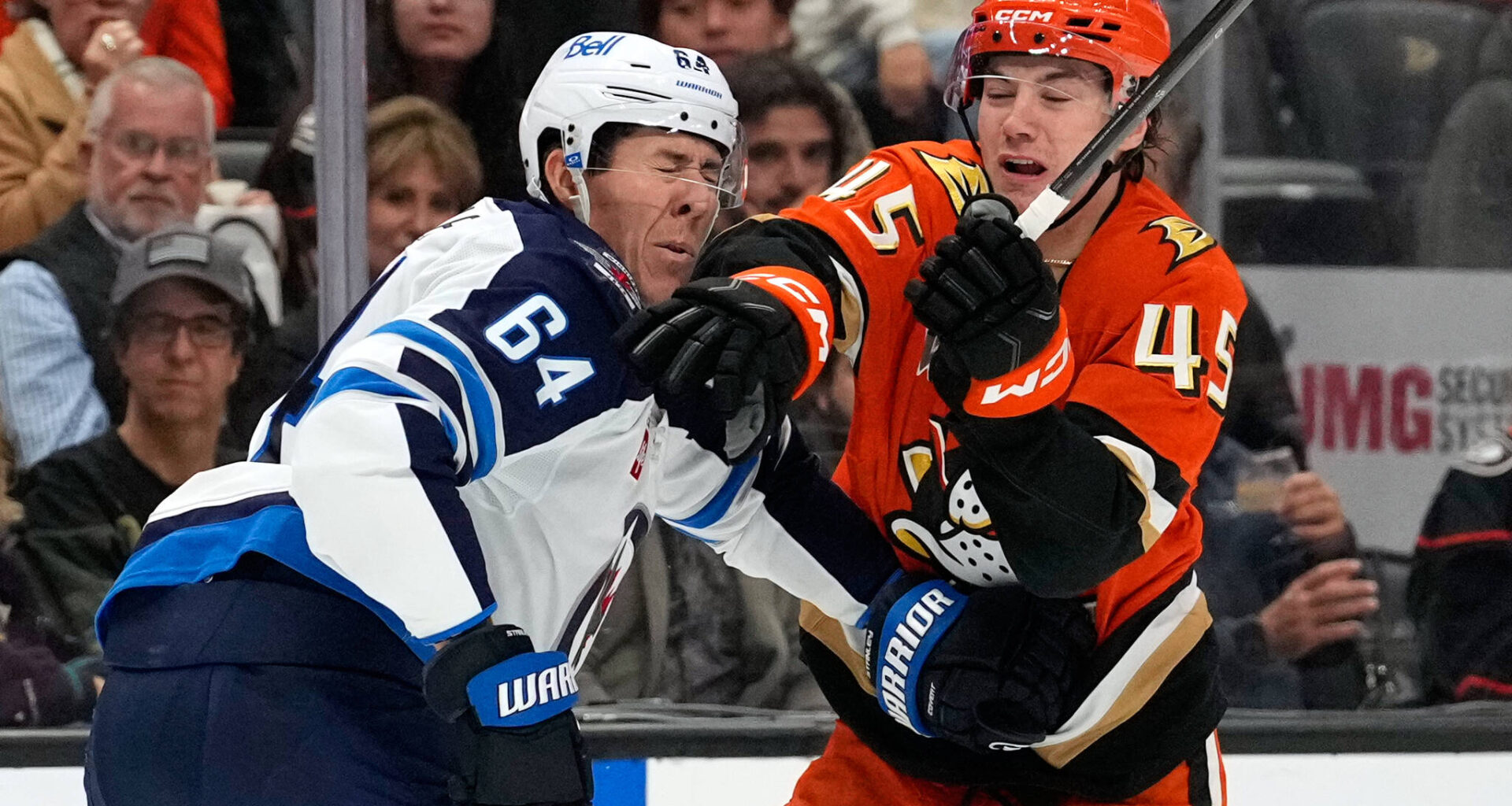 Winnipeg Jets defenseman Logan Stanley, left, is hit in the face by Anaheim Ducks right wing Beckett Sennecke during the first period of an NHL hockey game, Sunday, Nov. 9, 2025, in Anaheim, Calif. (Mark J. Terrill / The Associated Press)