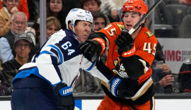 Winnipeg Jets defenseman Logan Stanley, left, is hit in the face by Anaheim Ducks right wing Beckett Sennecke during the first period of an NHL hockey game, Sunday, Nov. 9, 2025, in Anaheim, Calif. (Mark J. Terrill / The Associated Press)