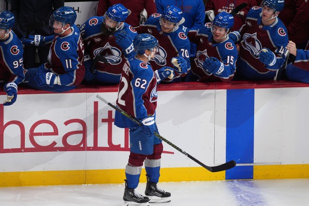 Colorado Avalanche left wing Artturi Lehkonen is congratulated as he...