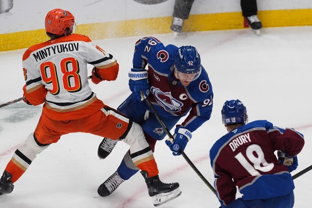 Ducks defenseman Pavel Mintyukov, left, blocks Colorado Avalanche left wing...