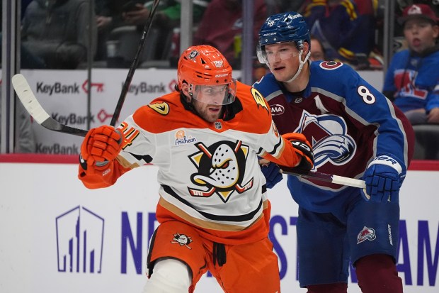 Colorado Avalanche defenseman Cale Makar, right, checks Ducks center Jansen...