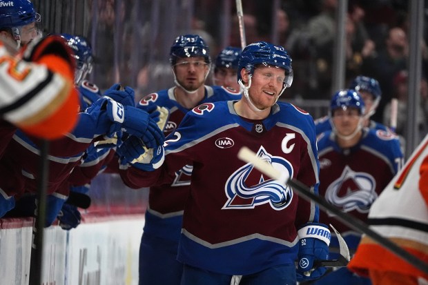 Colorado Avalanche left wing Gabriel Landeskog, right, smiles as he...