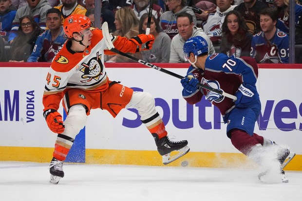 Ducks right wing Beckett Sennecke, left, loses control of the...