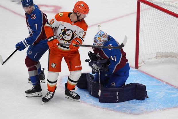 Ducks left wing Chris Kreider, center, redirects a shot at...