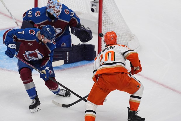 Ducks left wing Chris Kreider, front right, shoots the puck...