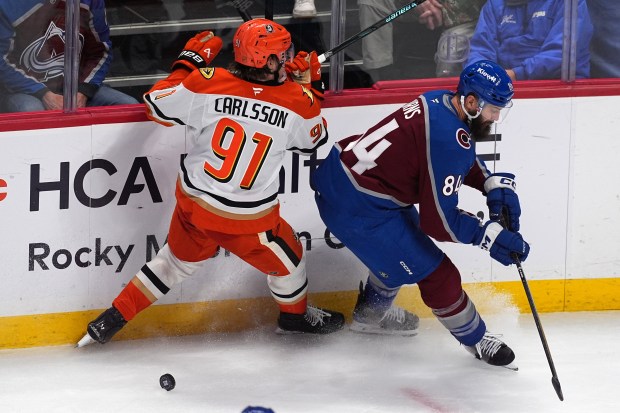 Colorado Avalanche defenseman Brent Burns, right, checks Ducks center Leo...