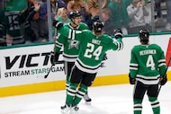 Dallas Stars left wing Jason Robertson (21), left, is congratulated by his teammate center...