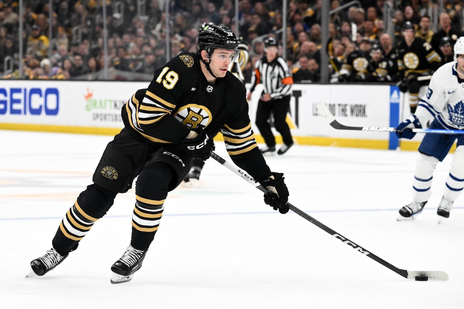 BOSTON, MASSACHUSETTS - APRIL 20: John Beecher #19 of the Boston Bruins skates with the puck against the Toronto Maple Leafs during the first period in Game One of the First Round of the 2024 Stanley Cup Playoffs at TD Garden on April 20, 2024 in Boston, Massachusetts. (Photo by Brian Fluharty/Getty Images)