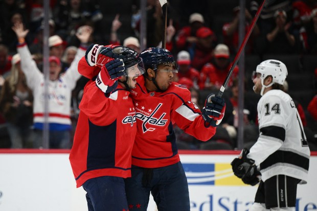 Washington Capitals defenseman Matt Roy, left, celebrates after his goal...