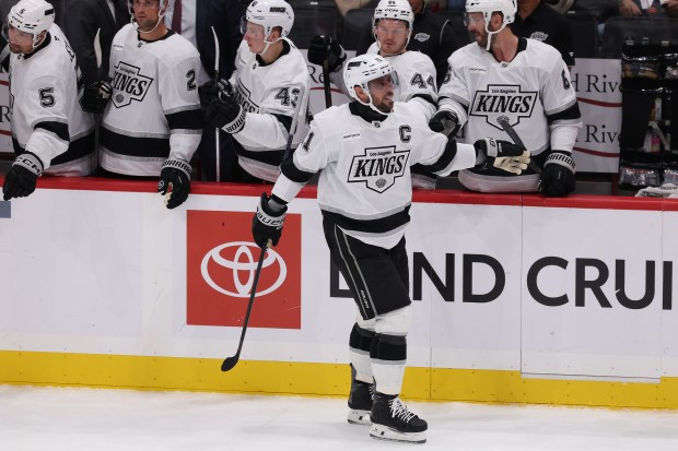 Kings captain Anze Kopitar (11) celebrates with teammates at the...