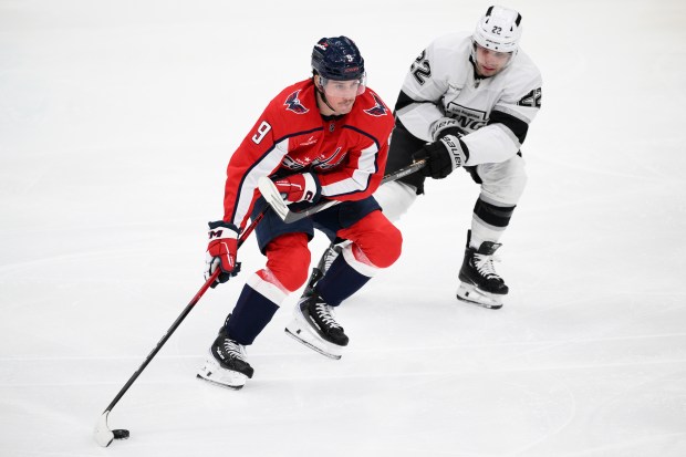 Washington Capitals right wing Ryan Leonard, left, skates with the...