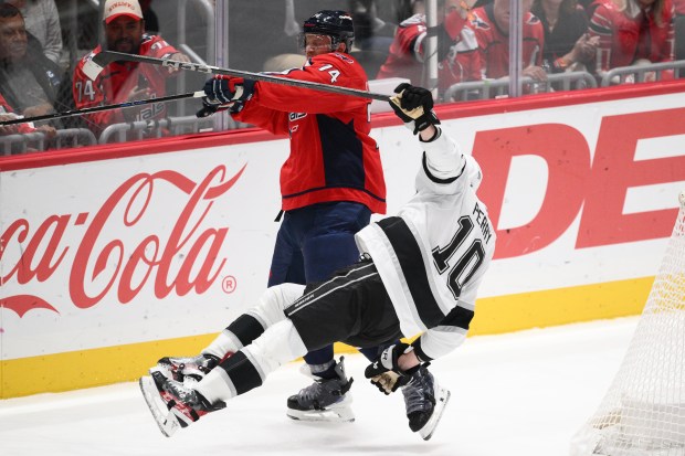 Washington Capitals defenseman John Carlson, top, and Kings right wing...