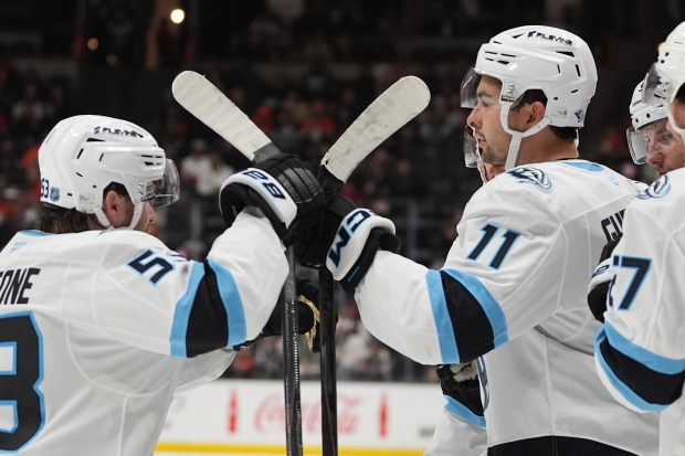 Utah Mammoth right wing Dylan Guenther (11) celebrates with teammate...