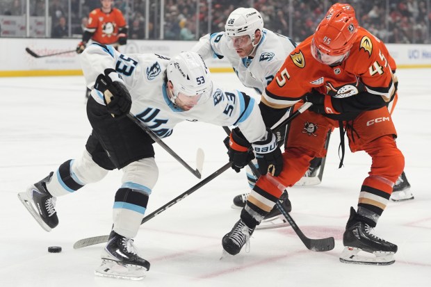 Ducks right wing Beckett Sennecke, right, battles Utah Mammoth left...
