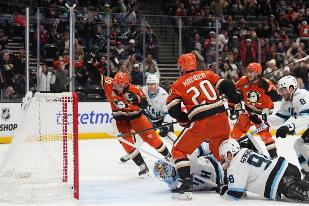 Ducks right wing Troy Terry, left, celebrates his game-tying goal...