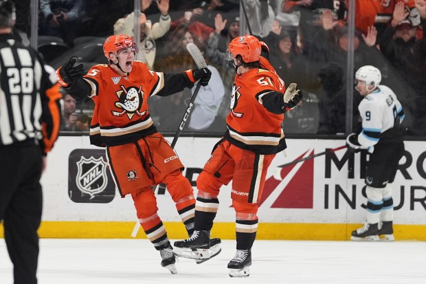 Ducks defenseman Olen Zellweger, right, celebrates his game-winning overtime goal...