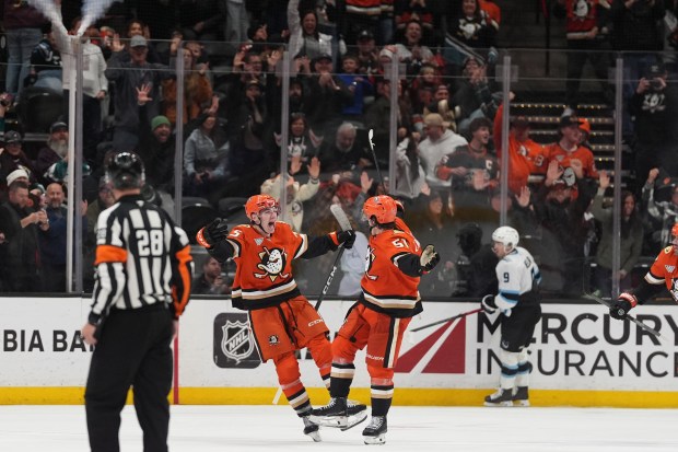 Ducks defenseman Olen Zellweger, right, celebrates his game-winning goal with...