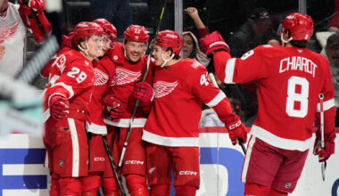 Detroit Red Wings center Nate Danielson, left, celebrates with teammates after scoring, a goal that on review was overturned on an off-side call, during the second period of an NHL hockey game against the Seattle Kraken, Tuesday, Nov. 18, 2025, in Detroit. (AP Photo/Ryan Sun)