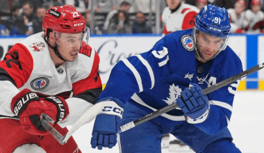 Toronto Maple Leafs forward John Tavares (91) and Carolina Hurricanes forward Logan Stankoven (22) chase after a loose puck during the first period at Scotiabank Arena.