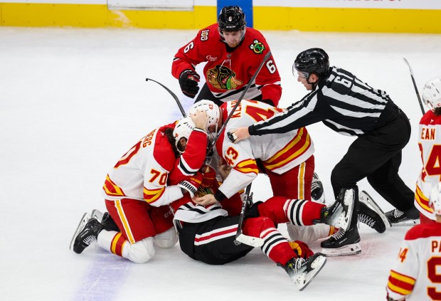 Defenseman Sam Rinzel (6) and Blackhawks teammates fight with Flames players at the end of the game Tuesday, Nov. 18, 2025, at the United Center. (Dominic Di Palermo/Chicago Tribune)