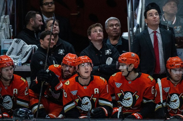 Ducks center Ryan Strome (16), center, and teammates watch from...