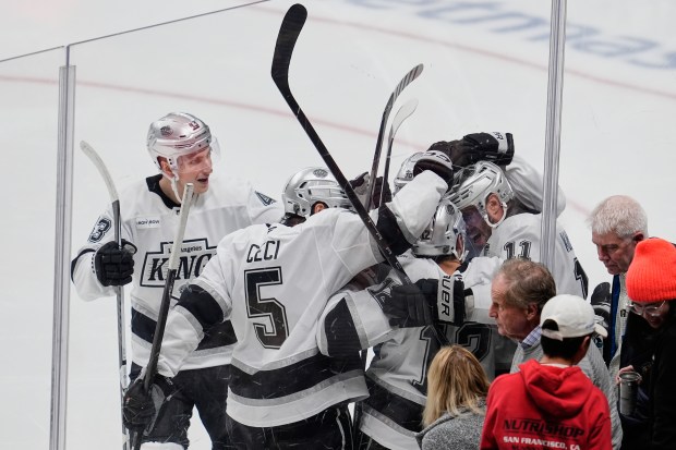 Kings center Anze Kopitar (11) celebrates with teammates after scoring...