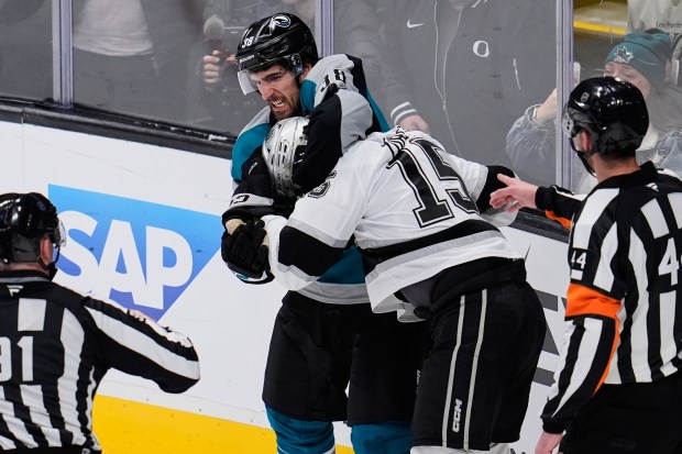 San Jose Sharks defenseman Mario Ferraro, top, and Kings center...
