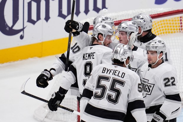 Kings right wing Adrian Kempe (9) celebrates with teammates after...